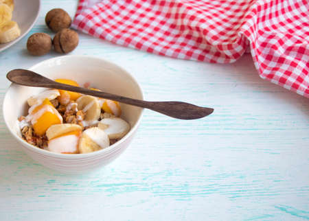 granola with fruit. A healthy breakfast of oatmeal with bananas and mangoes.の写真素材