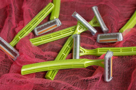 personal green razors on a red background. Lots of sharp new razorsの写真素材