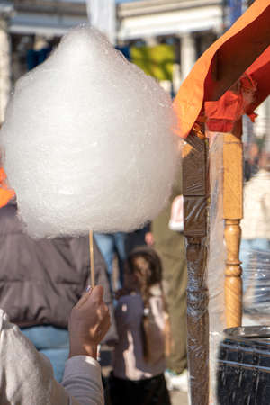 Street sweets. buying cotton candy at a street fair
