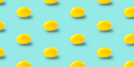 Juicy ripe flying yellow lemons on blue background. creative food concept.