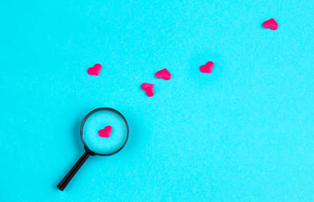 heart lies under a magnifying glass, among many other heartsの写真素材