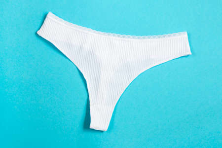White panties clothes on yellow background, top viewの写真素材