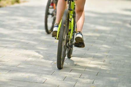 selective focus. cyclist on a bicycle leg and wheel close-up. Back view.