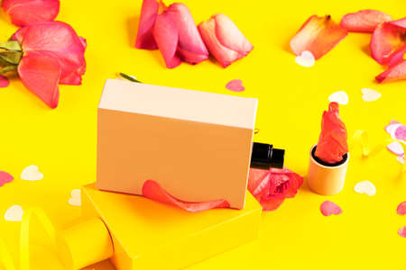 Open jar of perfume on a yellow background. Floral fragrance with roses.の写真素材