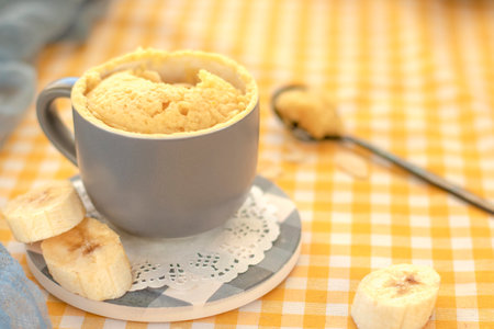mini cake. Breakfast in a mug. homemade Portioned Banana mugcake in small mugs.の写真素材