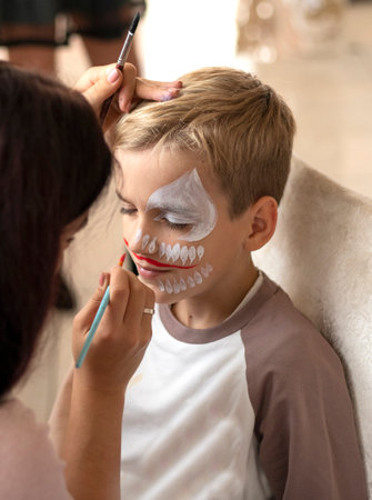 Master making aqua makeup on boys face. face painting kids.