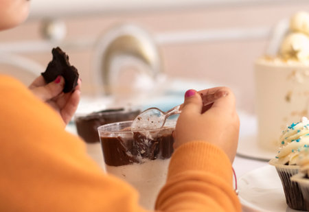 cute girl eating dessert. little sweet tooth overeats sweets.の写真素材
