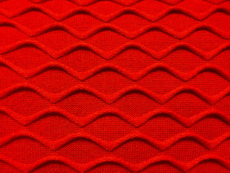 Pattern fabric made of wool. Handmade knitted fabric red wool background textureの写真素材
