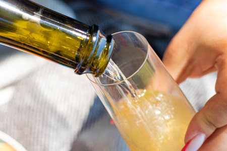 Wine. Glass of wine. Hands serving bottles of wine in transparent glasses