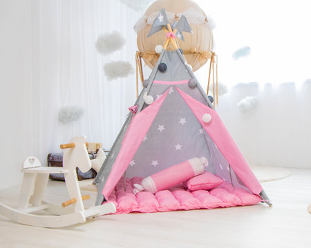 Playroom with Teepee. Modern room interior with play tent for child. pink wigwamの写真素材