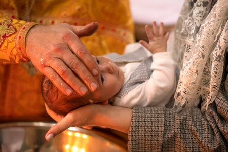 Ukraine, Khmelnitsky 02.10.2022. Infant baptism. Christian rite. Christeningのeditorial素材