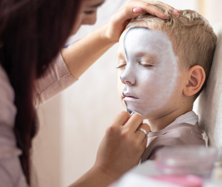 Master making aqua makeup on boys face. face painting kids.の写真素材