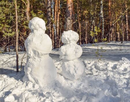 Snowman in the winter landscape in the forest. Undecorated snowman. Two snowmen.の写真素材