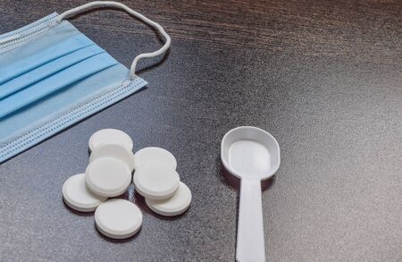 Medication and mask on a darkの写真素材