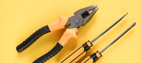 Layout of carpentry tools on a yellow background. Set of hand building tools. Equipment for the...