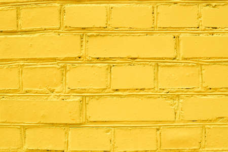 Abstract color brick wall texture background pattern, wall brick surface texture. Yellow colored...