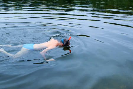 Man swimming in the sea wearing a mask.の写真素材