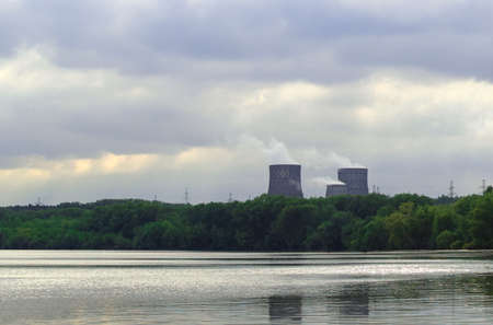 Industry and nature. Environmental pollution. Thermal power plant with huge chimneys. Selective...