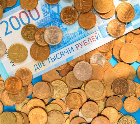 Russian paper rubles and metal Russian coins. World economic crisis. Cash loan. Selective focus.