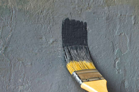 Painting an old wall with paint, painting tools.の写真素材