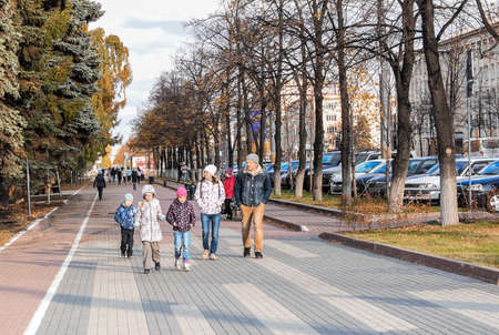Russia, Chelyabinsk, October 04, 2020: Family with children is walking around the autumn city. City landscape, family walk, weekend.のeditorial素材