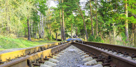 Image of an empty railroad track reaching a dead end. Rails converge at a railway dead end.の写真素材