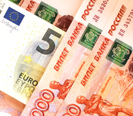Banknote 5 EURO on the background of banknotes 5000 rubles close-up. Ruble devaluation concept. Sanctions. Money background. Selective focus.の写真素材