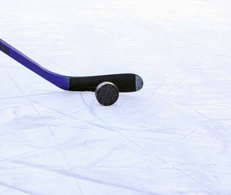 Hockey stick with black tape and puck. Copy space. Selective focus. Blurred background.の写真素材