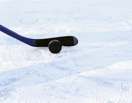 Hockey stick with black tape and puck. Copy space. Selective focus. Blurred background.の写真素材