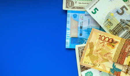 Banknotes of the USA, Europe, Russia and Kazakhstan on a blue background. Currency exchange concept....