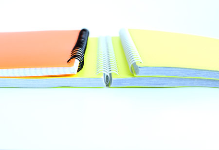 Bright school notebooks background isolated on white background. Back to school. Copy space. Selective focus.の写真素材