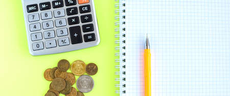 Notebook, pen, calculator, coins. Money counting concept.の写真素材
