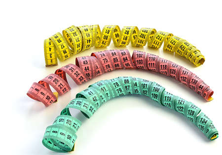 Colored centimeter tape, twisted in a spiral, isolated on a white background. Top view, measurement of dimensions. Diet and weight loss concept. Selective focus.の写真素材
