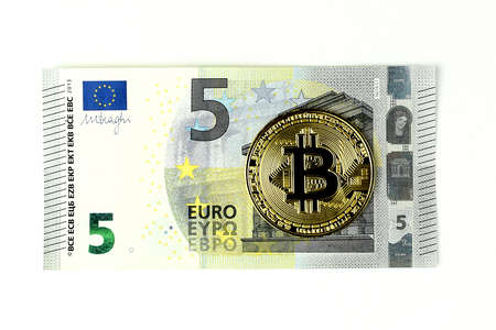 Golden bitcoin and 5 euro note isolated on white background. Flat lay. Mining concept, cryptocurrency, digital money.の写真素材