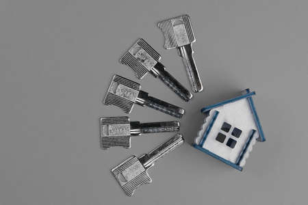 Conceptual composition: House keys and house model. Top view, flat lay. Real estate purchase concept.の写真素材