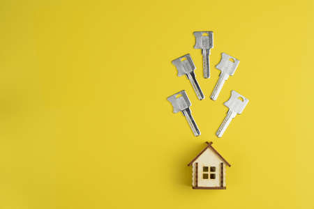 Conceptual composition: House keys and house model. Top view, flat lay. Real estate purchase concept.の写真素材