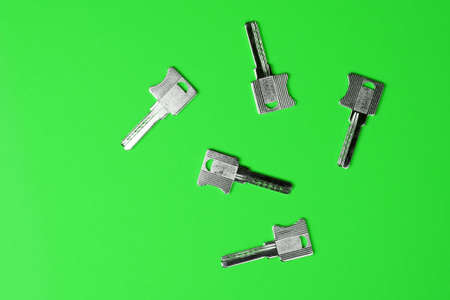 Keys on bright colored background, flat lay, trendy colorful photo with colored paper.の写真素材