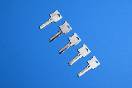 Keys to the lock on colored watercolor paper, top view. fashionable colorful photo. Trendy flat lay.