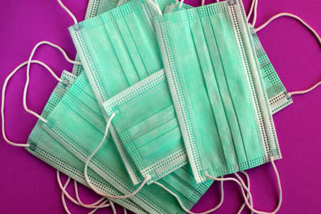 Medical masks on a colored background. The concept of medicine and protection against virus. Top...