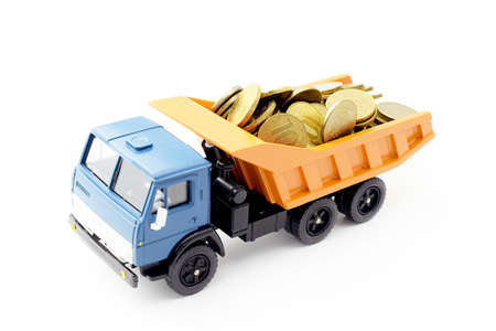Toy truck transports metallic money, isolate on white. Economic sanctions against Russia. Export of money.の写真素材