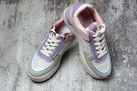 Sports sneakers with laces, on a concrete background. Sport shoes. Side and top view.の写真素材