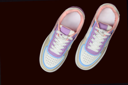 White sneakers isolated on black background. fashionable sports shoes. Top view, flat lay.の写真素材