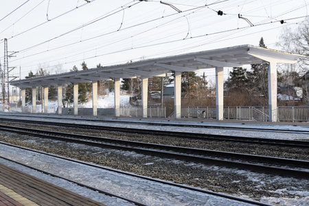 Empty railway tracks and empty passenger platform. Railway station.の写真素材