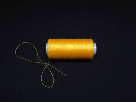 spool of thread on a black backgroundの写真素材