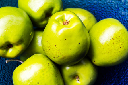 Green large apples in a blue vase lieの写真素材