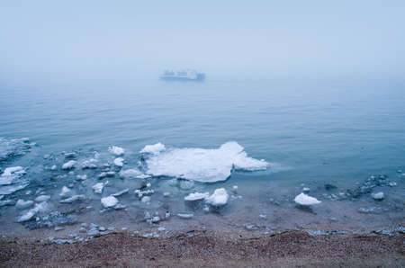 Motor boat in the fog in winter.