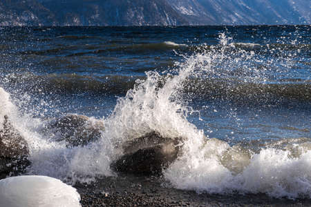 Big waves crash on the shoreの写真素材