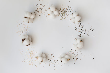 A circle of cotton flowers creates a place for your text. Glitter give the image lightness and dynamics.の写真素材