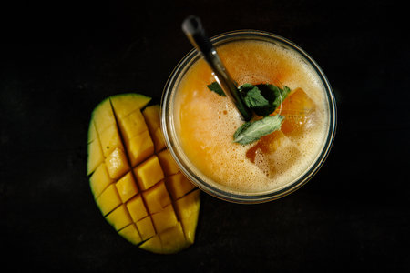 An invigorating non-alcoholic cocktail with mango pulp, mint leaves and ice cubes. Flat lay.の写真素材
