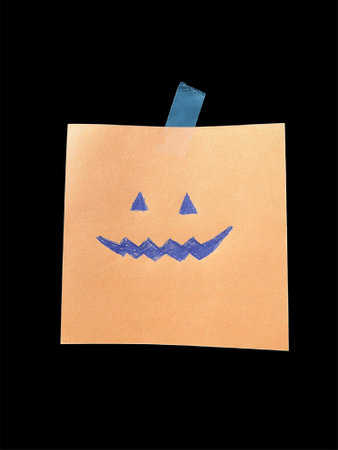 Halloween concept. Scary pumpkin or jack o lantern paper craft on dark black background with copy space. High quality photoの写真素材
